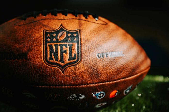 Close-up of an NFL football on grass.