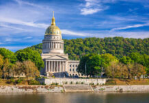 West Virginia State Capitol building with a golden dome surrounded by trees