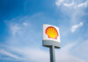 Shell gas station sign against a clear blue sky
