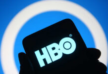 HBO logo displayed on a smartphone against a blue background