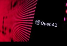 Close-up of a smartphone displaying the OpenAI logo against a vibrant digital background