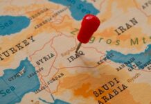 A map of the Middle East with a red pin marking Iraq
