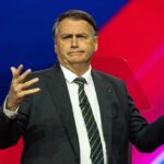 A politician gesturing while speaking at a podium