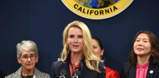 A woman speaking at a press conference with other women in the background