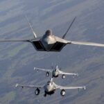 Three military fighter jets flying in formation in the sky