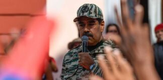 A leader in military attire speaking to a crowd