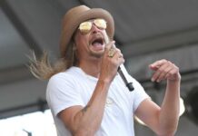 Musician performing on stage with a microphone