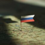 A small Russian flag pinned on a map of Moscow