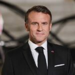 Emmanuel Macron in formal attire at a state event