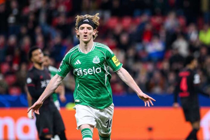 Soccer player in green jersey celebrating a goal