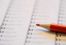 Close-up of a voting ballot with a red pencil