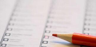 Close-up of a voting ballot with a red pencil