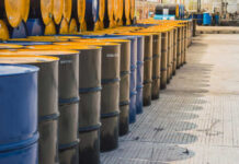 Rows of oil barrels in an industrial setting