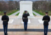Military personnel saluting at the Tomb of the Unknown Soldier