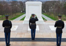 Military personnel saluting at the Tomb of the Unknown Soldier