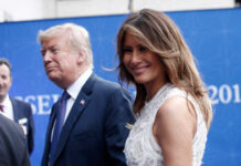 A couple at a political event, with one person smiling at the camera