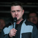 Man speaking into a microphone at an outdoor event