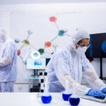 Scientists in a lab conducting research with equipment and a computer