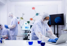 Scientists in a lab conducting research with equipment and a computer