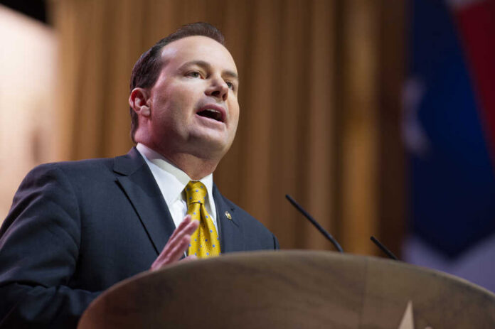 A man in a suit delivering a speech at a podium