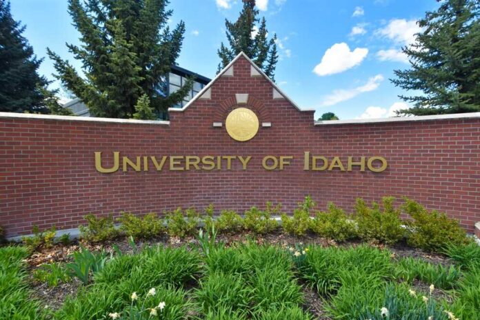 Sign for the University of Idaho displayed on a brick wall