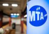 MTA sign in a subway station with blurred background