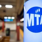 MTA sign in a subway station with blurred background
