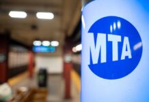 MTA sign in a subway station with blurred background