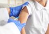 A healthcare professional administering a vaccine to a child's arm