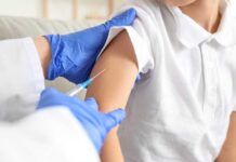 A healthcare professional administering a vaccine to a child's arm