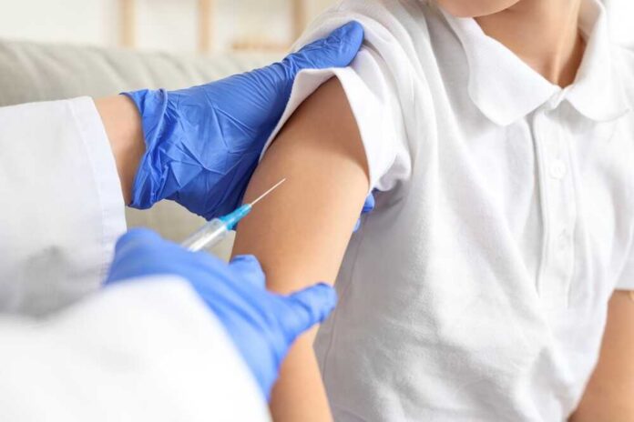 A healthcare professional administering a vaccine to a child's arm