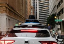 Rear view of a Waymo autonomous vehicle on a city street