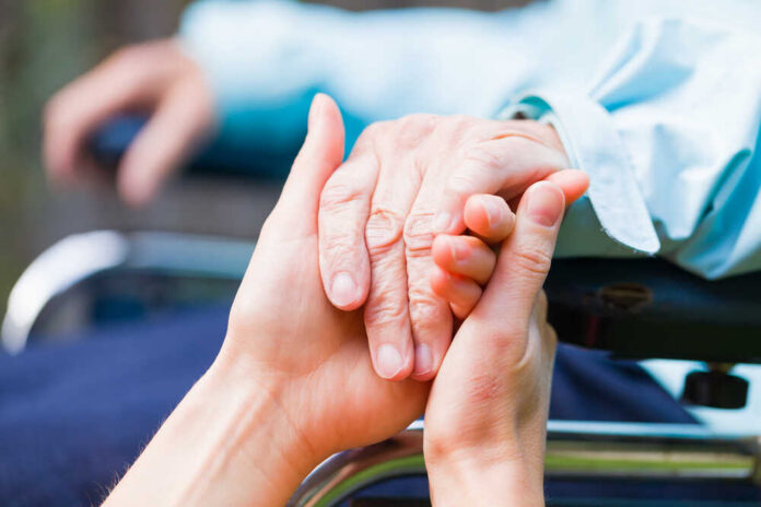 Two hands clasped together, symbolizing care and support