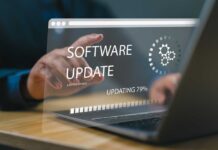 User interacting with a laptop displaying a software update progress