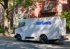 Brinks security truck parked on a city street near residential buildings