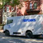 Brinks security truck parked on a city street near residential buildings