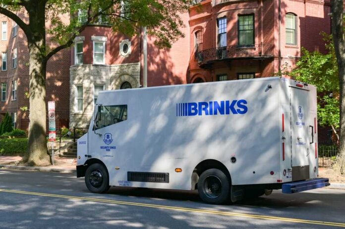 Brinks security truck parked on a city street near residential buildings