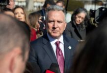 A politician speaking to the media during a press conference