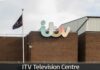 Exterior view of the ITV Television Centre with a flag and signage