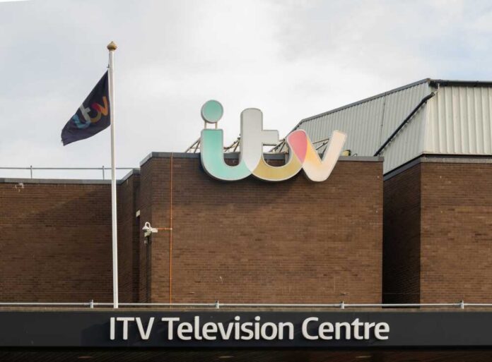 Exterior view of the ITV Television Centre with a flag and signage