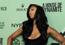 A celebrity posing on the red carpet at a fashion event