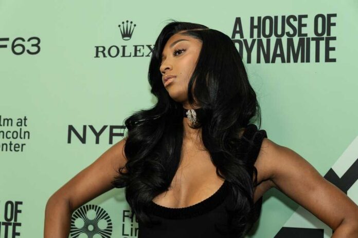 A celebrity posing on the red carpet at a fashion event