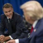 Two political leaders engaged in a conversation, one smiling