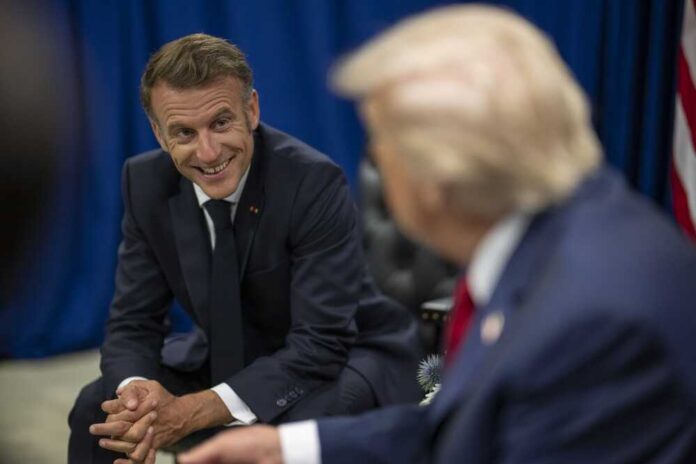 Two political leaders engaged in a conversation, one smiling