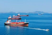 Several cargo ships navigating in a calm ocean