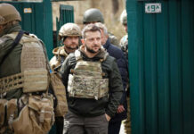 Group of soldiers, including Volodymyr Zelenskyy, wearing tactical gear.