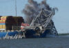Ship crashing into a collapsing bridge structure.