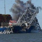 Ship crashing into a collapsing bridge structure.