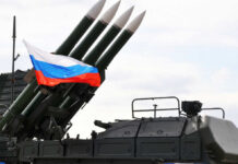 Military launcher with four missiles and Russian flag