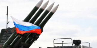 Military launcher with four missiles and Russian flag
